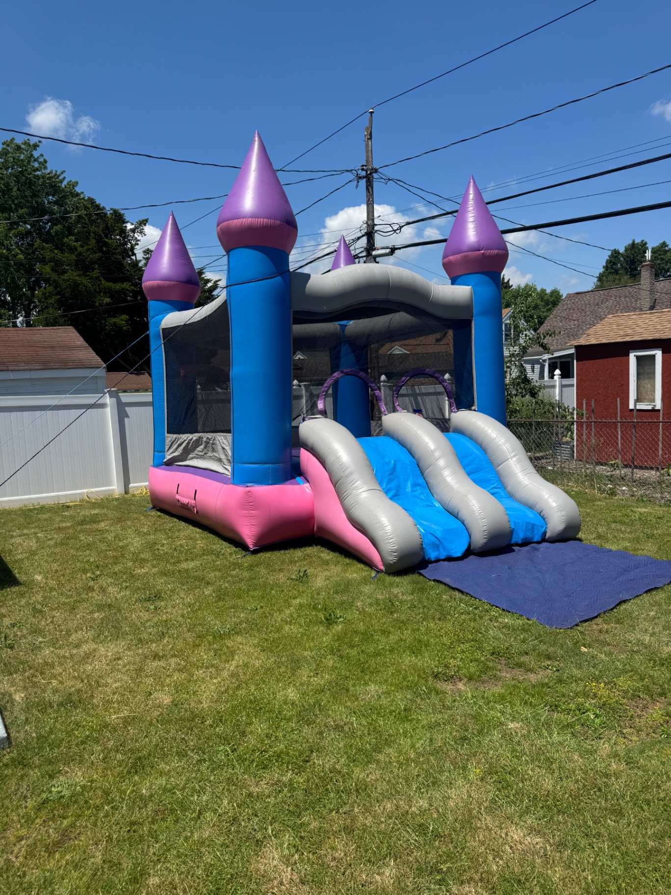 Princess combo bounce house with slide set up in a yard